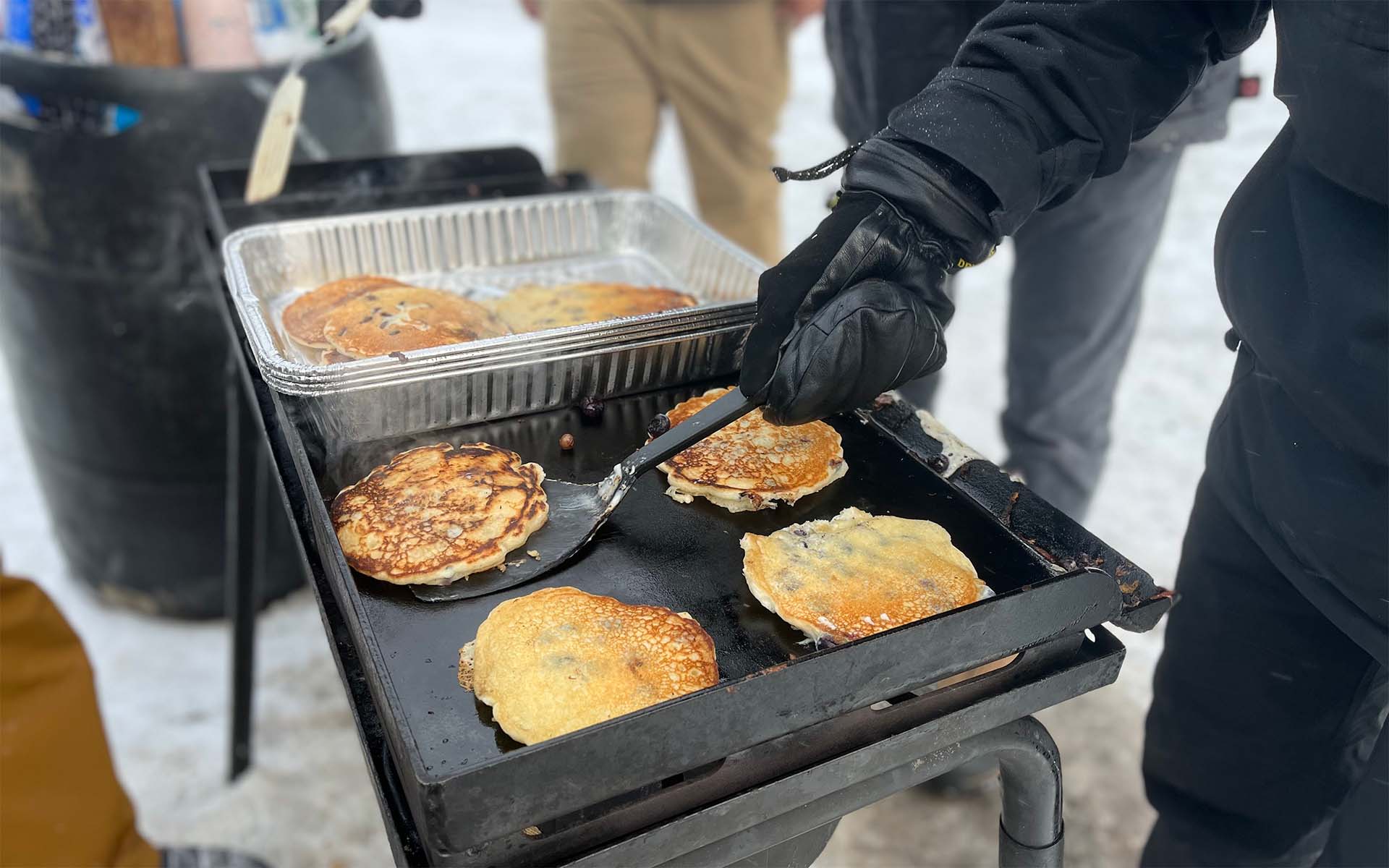 Snowboarders and Skiers for Christ making pancakes at Loveland Ski Area